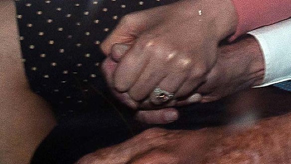 Iron grip ... Wendi Deng holds her husband's hand as they arrive back at his London home after he gave evidence.