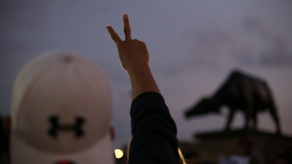 A supporter of Bongbong Marcos makes a "V" for victory sign at protest in Manila on Wednesday.