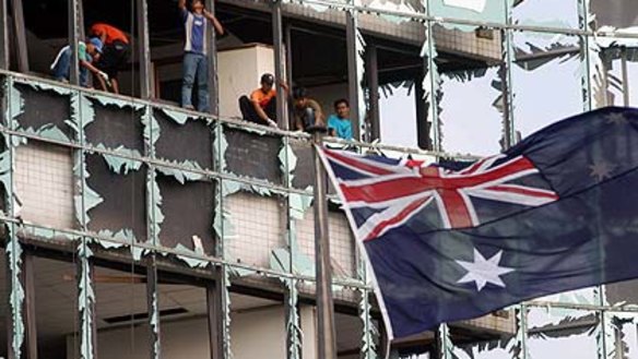 Flashback ... workers remove broken glass from the Australian  embassy in Jakarta after a bombing in 2004.