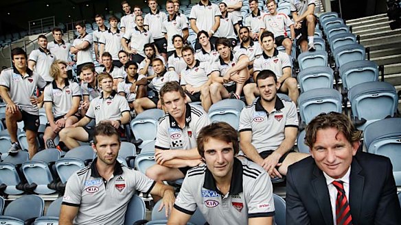 All together now: Jobe Watson (front, centre) and coach James Hird (right) with the 2012 Essendon playing list yesterday.