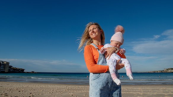 Annie Slattery, who immigrated from Ireland in 2009, with her baby daughter Romy at Bondi. 