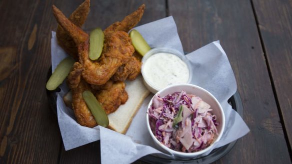 Fried chicken wings and purple cabbage coleslaw.