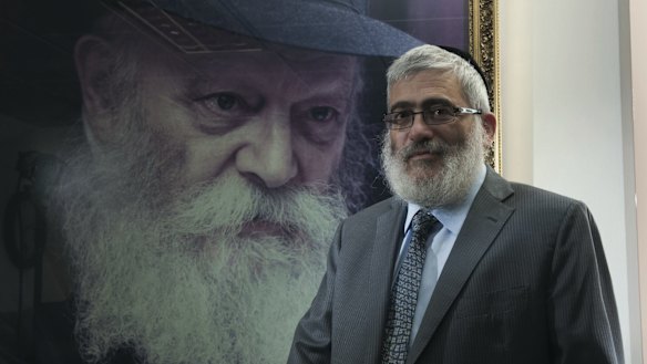 'Diamond Joe' Gutnick in front of a painting of Rabbi Menachem Mendel Schneerson, the last Lubavitcher Rebbe.