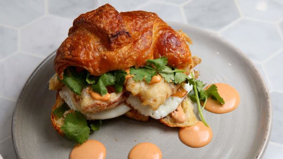 The definition of 'nom': Soft-shell crab croissant burger with chipotle mayo.