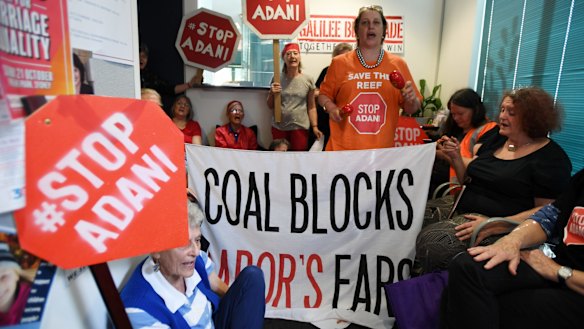Protesters in Sydney make their views on Adani clear. The NAIF is considering a $1 billion loan to a company associated with Adani Group patriarch Gautam Adani. 