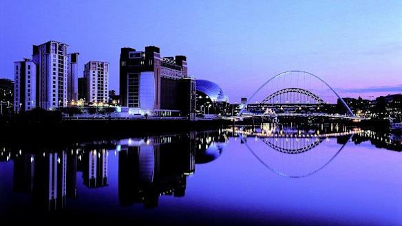 Newcastle by night: The redeveloped Tyne River waterfront and Gateshead Millennium Bridge.
