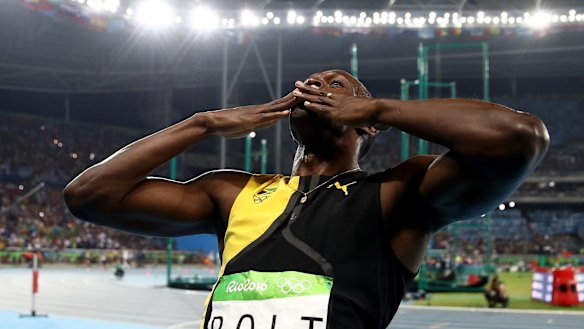 A kiss to the crowd: Usain Bolt celebrates his victory.