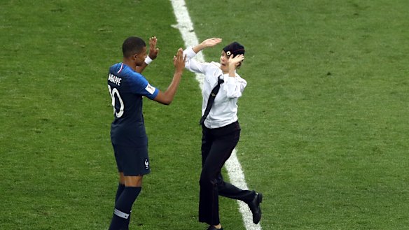 One of the protesters approached France's Kylian Mbappe.