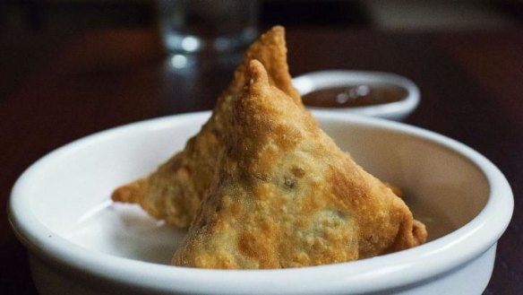 Vegetarian samosas with sweet and sour chutney.