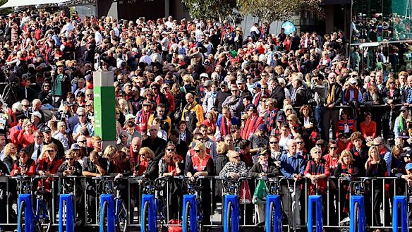 A huge crowd masses at Federation Square to watch the funeral across the road.
