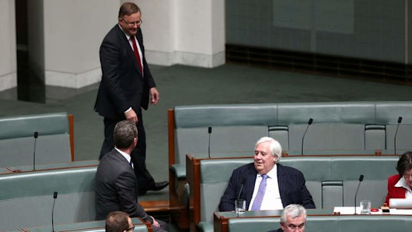 Leader of the House Christopher Pyne, opposition infrastructure and transport spokesman Anthony Albanese and Palmer United Party leader Clive Palmer in discussion during question time. Photo: Alex Ellinghausen