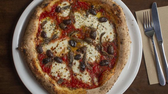 The Napoli pizza has san marzano tomatoes, fior de latte, anchovy, olives and oregano.