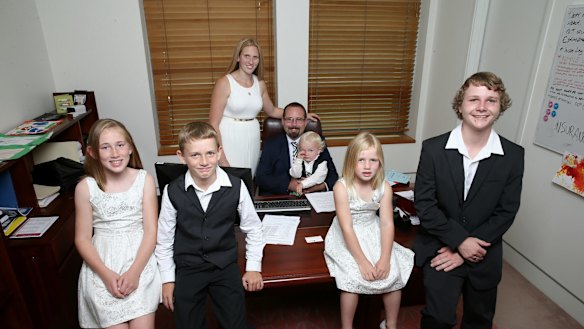 AMEP Senator Ricky Muir and partner Kerrie-Anne, together with their five children (L-R) Phoenix, William, Tristan, Tarja and Dylan in his office ahead of his first speech to the Senate, at Parliament House in Canberra on Thursday.