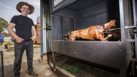 Robert Azbajic is attracting crowds of hungry travellers with his spit roast pig and lamb kebabs.