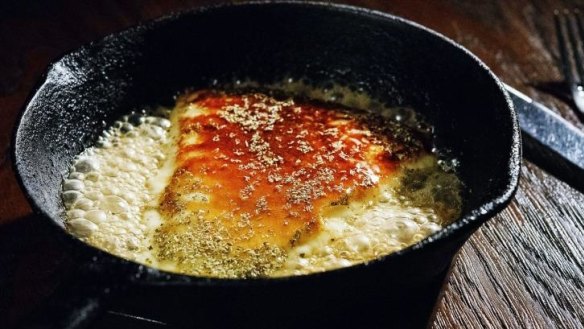 Saganaki cheese with honey and oregano at The Apollo in Sydney.