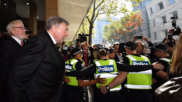 Cardinal Pell leaves the court with lawyer Robert Richter, QC.