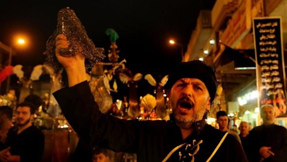 Centuries-old ritual: A Shiite Muslim man flagellates himself during an Ashura procession to the Shrine of Imam Musa al-Kadhim in Baghdad's northern suburb of Kadhimiya on Thursday.
