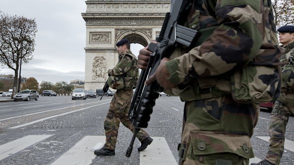 French soldiers cross the Champs Elysees avenue in Paris.