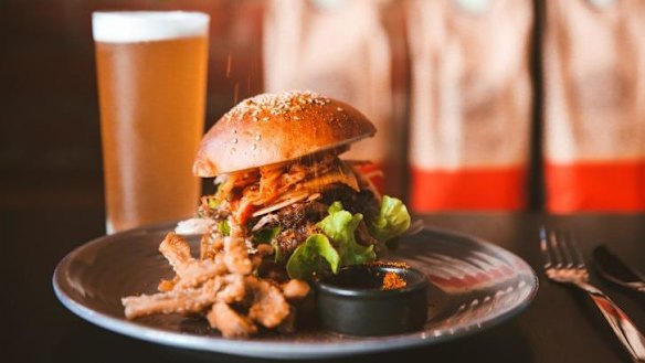 Pulled pork burger with kimchi and fennel and apple slaw.