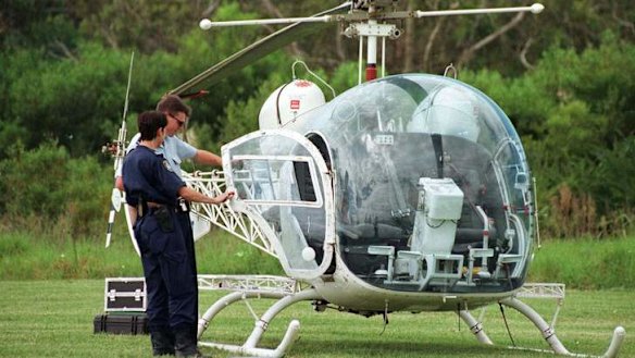 Police examine the helicopter John Killick used to escape Silverwater jail in 1999.