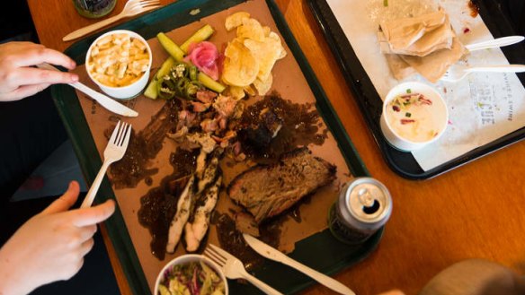 Tucking into a barbecue meat plate.