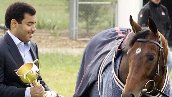 One proud owne, one weary horse ... Sheikh Fahad Al-Thani shows French Stallion Dunaden the spoils of his win in the 2011 Melbourne Cup. The six-year-old won the race by the narrowest margin in its history.