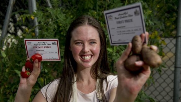 Sustainability project officer Eliza Hopkins with some of the school's Royal Canberra Show prize-winning tomatoes and potatoes.