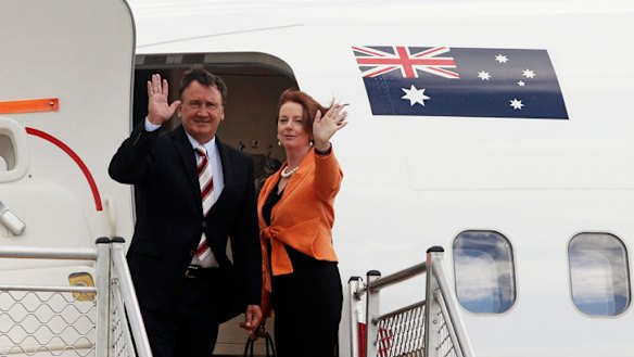 Julia Gillard and partner Tim Mathieson leave Melbourne for Singapore yesterday.