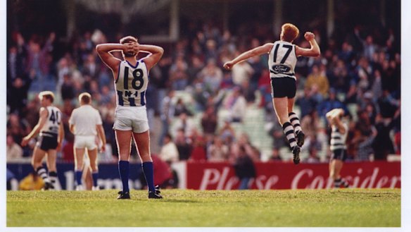 Tim McGrath celebrates the after-the-siren goal by Gary Ablett while North Melbourne's Wayne Carey looks on.