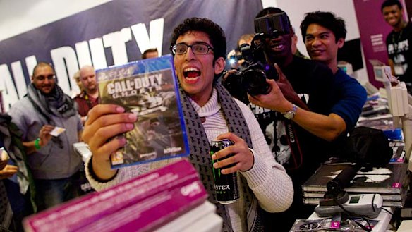 The first customer picks up his copy of Call of Duty: Ghosts in London this week.