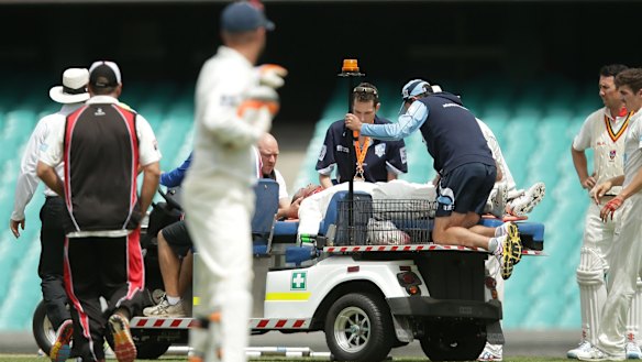 Phil Hughes is stretchered off the SCG.