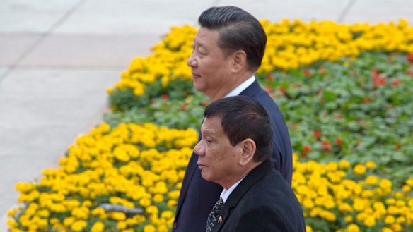 Philippine President Rodrigo Duterte, front, walks with Chinese President Xi Jinping outside the Great Hall of the People in Beijing, China this week.