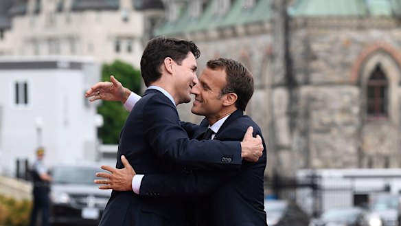 Justin Trudeau and Emmanuel Macron embrace in Ottawa ahead of the G7 summit.