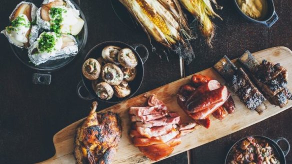 The gathering feast: a platter of meat and sides for four people.