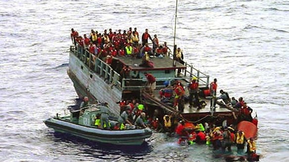 Australian navy personnel rescue asylum-seekers from a sinking boat off Christmas Island in 2001. The Howard Government later falsely claimed the refugees had thrown children overboard. <i>The Age</i> has tracked down an interviewed asylum seekers involved with the Tampa. Their stories are on this page.