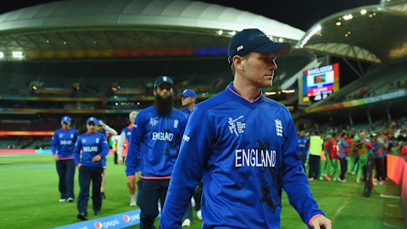 Humiliated: England captain Eoin Morgan leads a line of dejected players off the field.