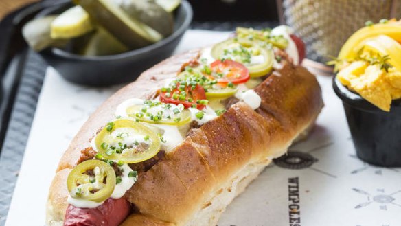 Spicy hotdog with sour cream, cheese and jalapenos.