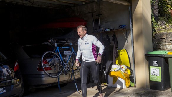 Tony Abbott returns home after a bike ride and a swim on Sunday. 
