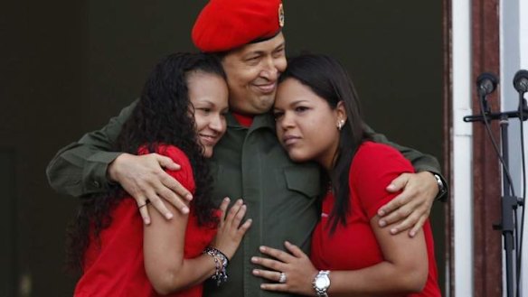 Hugo Chavez hugs his daughters Rosa and Maria.