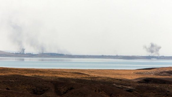 On target: Smoke rises following US air strikes on Islamic State militants at Mosul Dam on Monday.