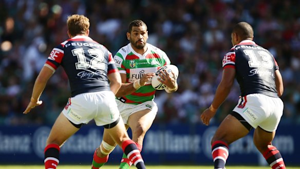 Hard to stop: Greg Inglis takes on the defence during the round one NRL match between the Sydney Roosters and the South Sydney Rabbitohs at Allianz Stadium.
