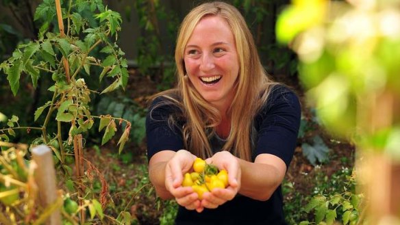 Virginia Meager with her yellow pear tomatoes in the backyard of her Chapman home.