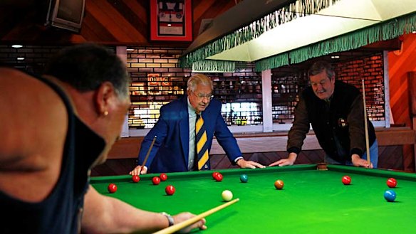 Final rounds … the Clovelly RSL president Jim Rankin, centre, plays snooker with club members John Heperi, left, and Tim McAuliffe.
