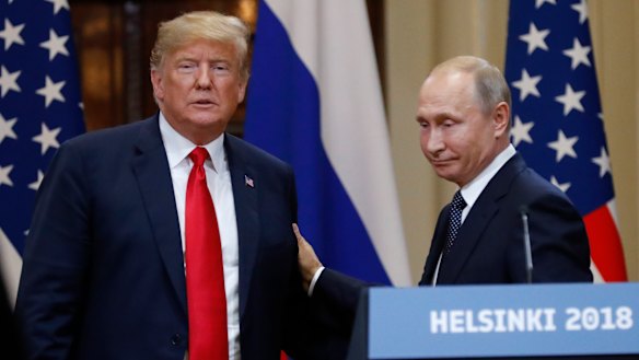U.S. President Donald Trump, left, and Russian President Vladimir Putin leave after a press conference after their meeting at the Presidential Palace in Helsinki, Finland.