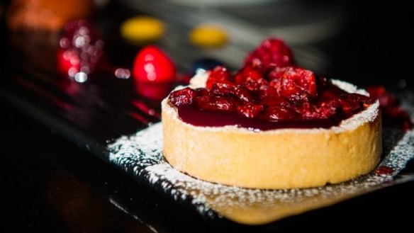 Cranberry tart with dark chocolate mousse, wild berries and chocolate tuille.