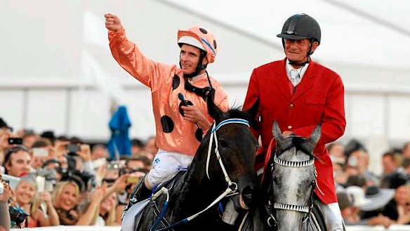 Jockey Luke Nolen salutes the crowd after winning the TJ Smith Stakes aboard the undefeated Black Caviar.