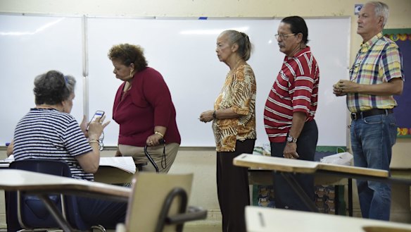 Residents line up to vote during a US election.