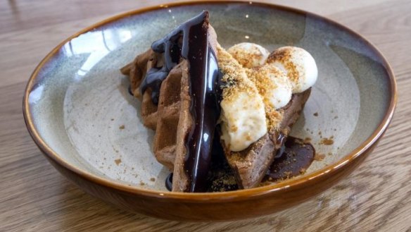 S'more ice-cream sandwich with torched marshmallow and chocolate fudge.