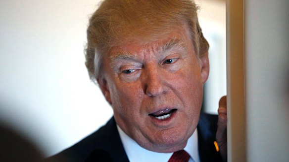 President Donald Trump speaks with reporters on Air Force One.