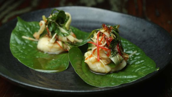 Mango, Thai sausage, cucumber and herbs on a smoked scallop, served on betel leaves.